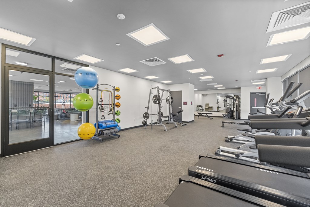 a spacious fitness center with treadmills and weights
