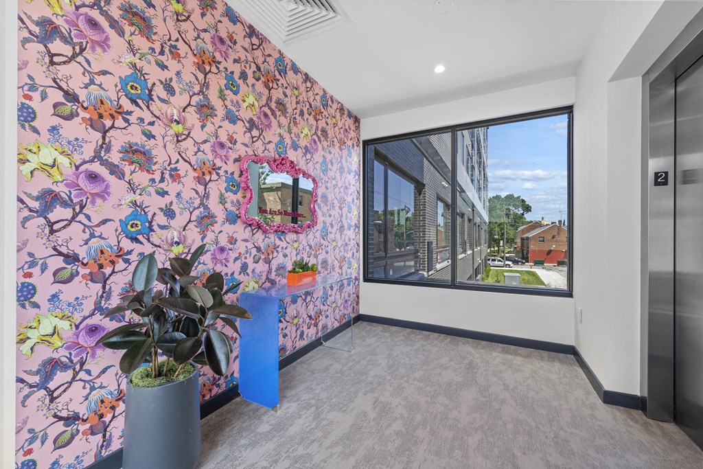 a colourful corridor with a large window and a potted plant