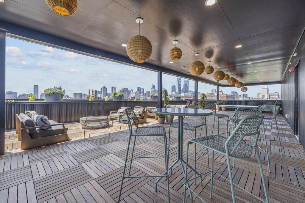 a rooftop bar with a view of the city