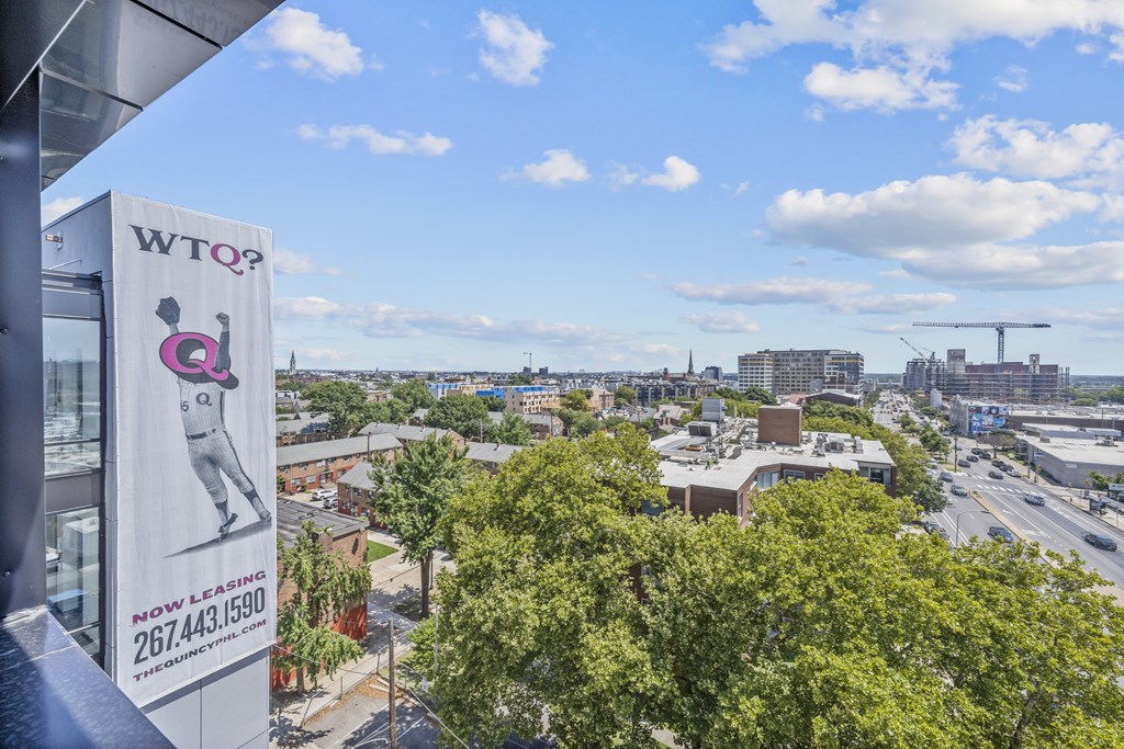 a view of a city with a sign on the side of a building