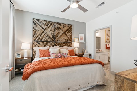 a bedroom with a bed and a ceiling fan