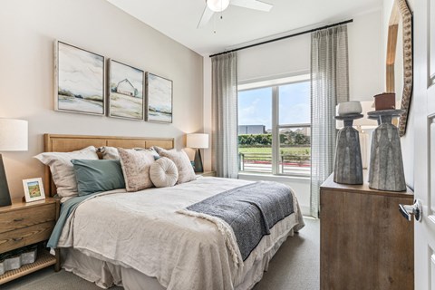Large bedroom with dresser at Alta Riverside Las Colinas apartments in Irving, TX.