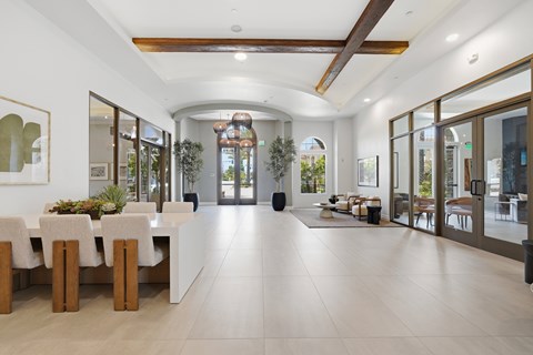 A spacious dining area with a long table and chairs.