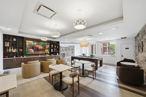 A modern living room with a dining table and chairs.