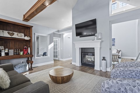 A living room with a grey couch and a wooden coffee table.