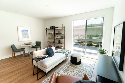 a living room with a couch and a table and a window