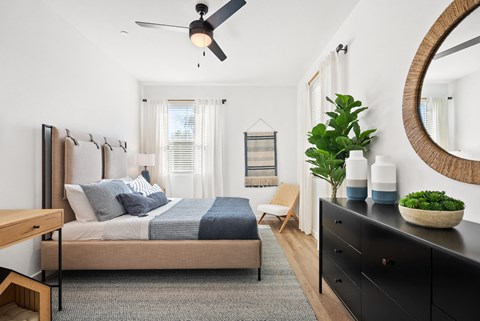 a bedroom with a bed and a ceiling fan