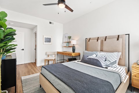 a bedroom with a large bed and a ceiling fan