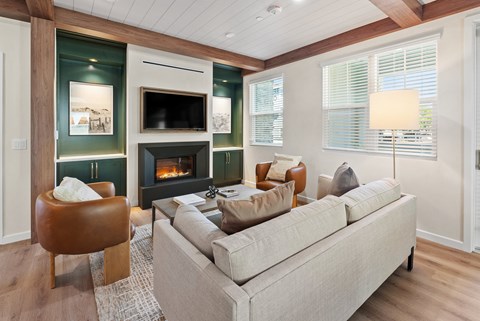 a living room with a couch and chairs and a fireplace