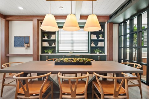 a dining room with a wooden table and chairs