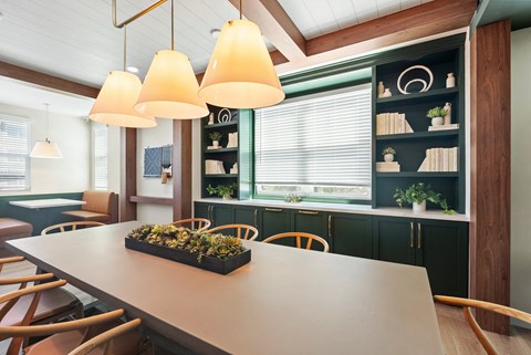 a dining room with a table and chairs and a window
