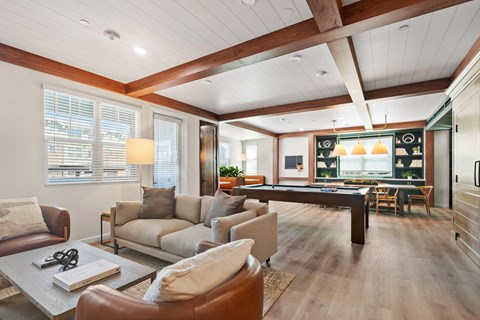a living room with couches and a pool table