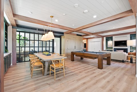 a large living room with a pool table and a dining table