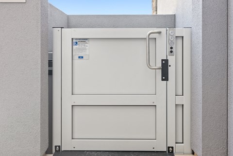 a white door with a handle on the side of a building