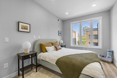 a bedroom with a large bed and a large window