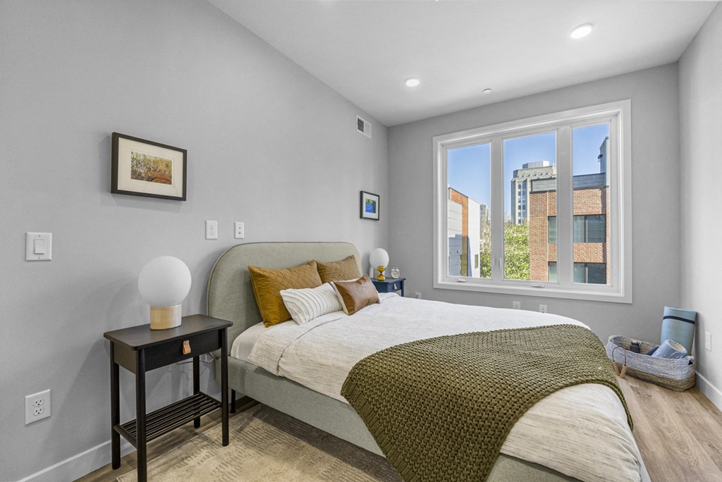 a bedroom with a large bed and a large window