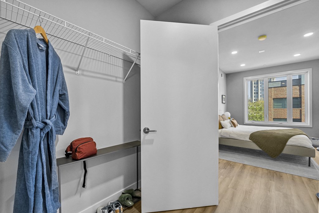 a bedroom with a bed and a window in a 555 waverly unit