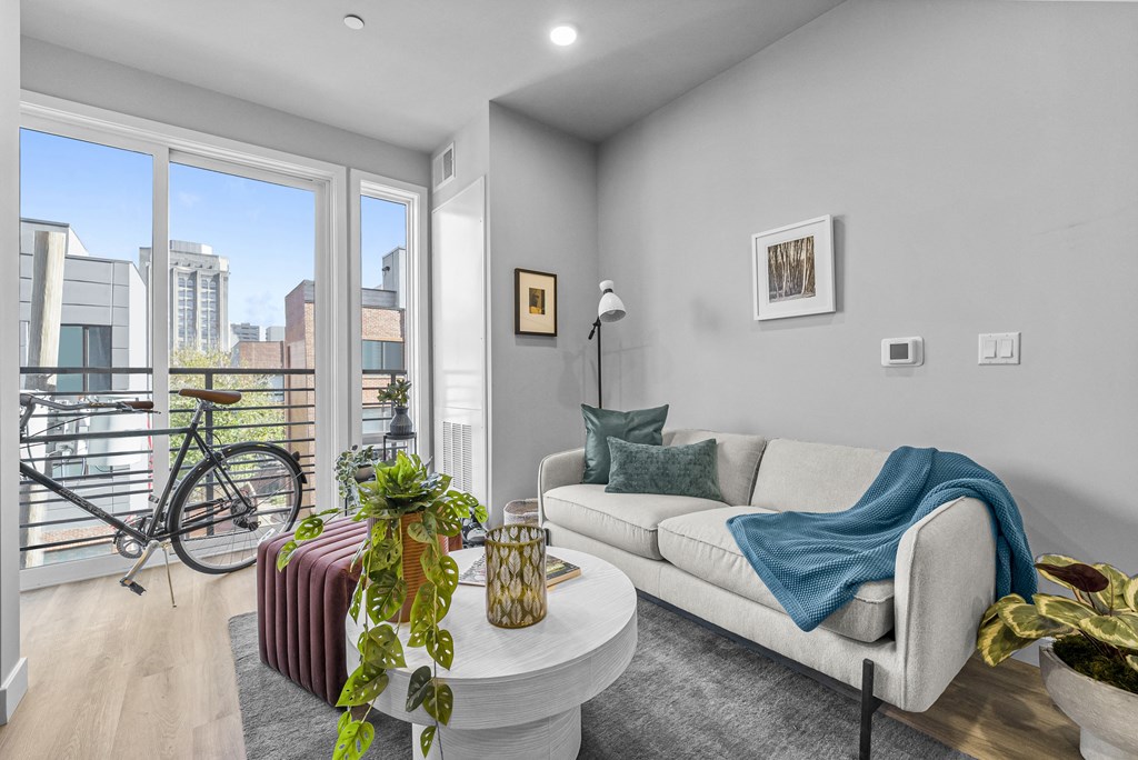 a living room with grey walls and a large window