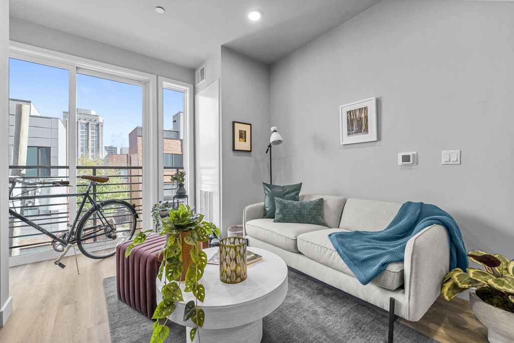 a living room with grey walls and a large window