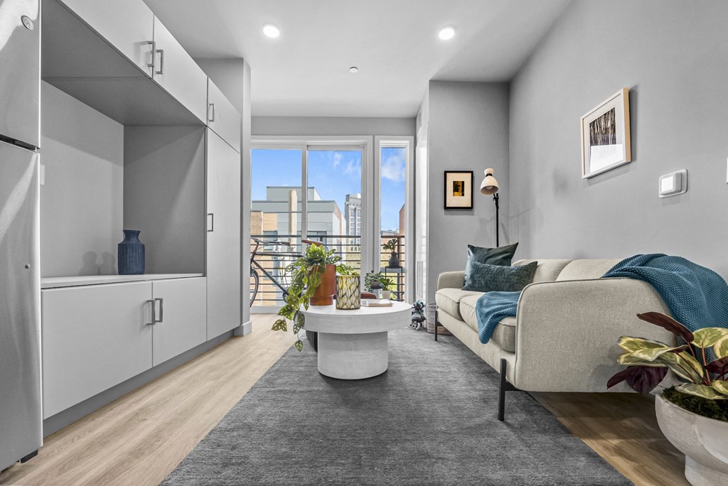 a living room with grey walls and hardwood floors