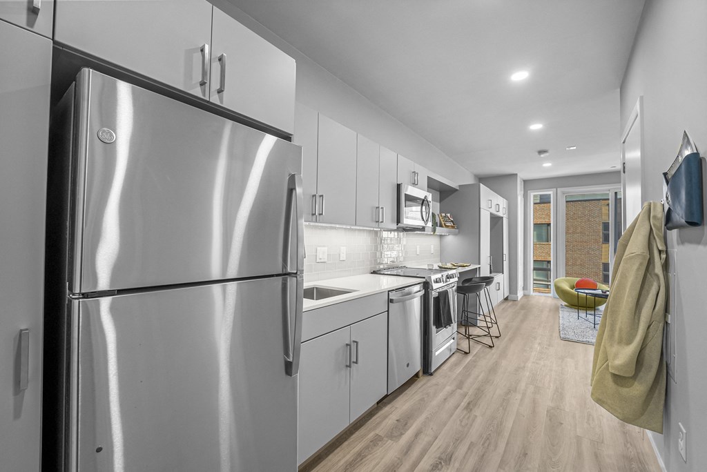 a kitchen with white cabinetry and stainless steel appliances