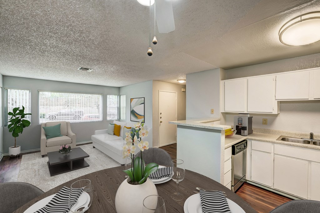 a living room and kitchen with a table and chairs