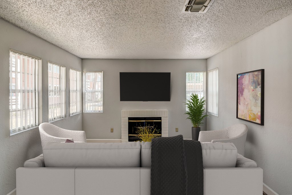 a living room with a white couch and a fireplace and a television