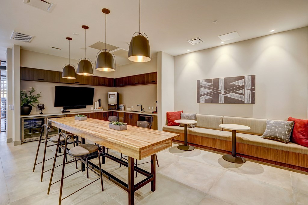 a kitchen and living room with a wooden dining table