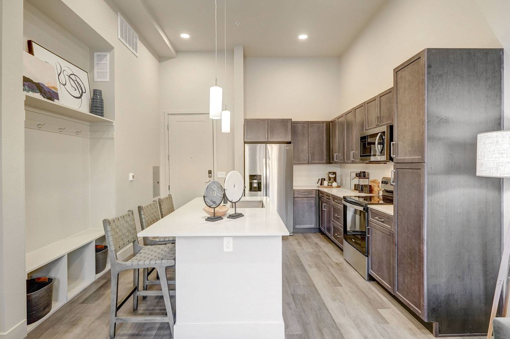 Kitchen with built-in mudroom space with hooks and shelving
