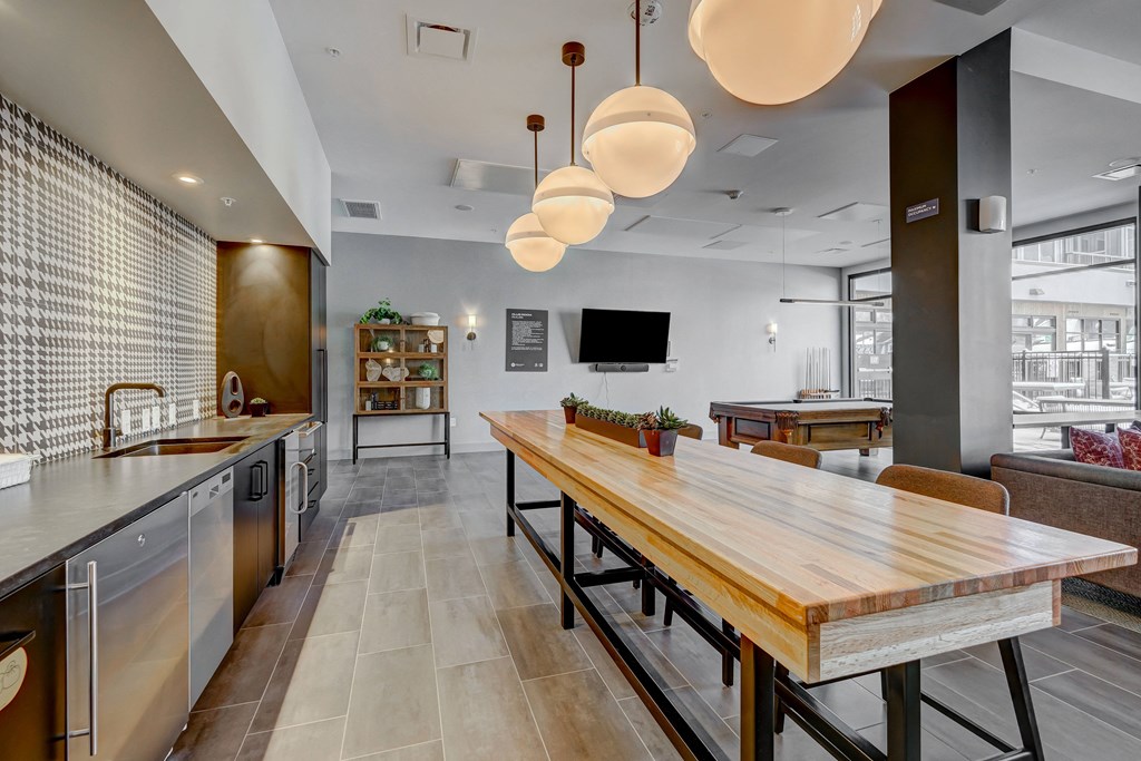 a kitchen and dining area with a wooden table and chairs