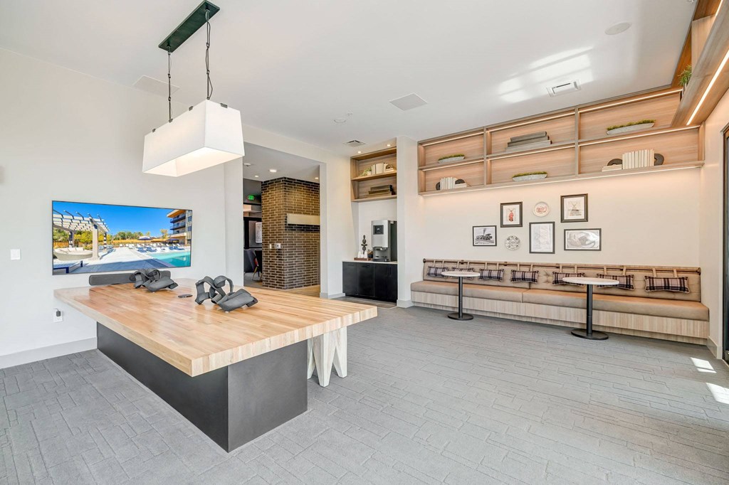 Co-working space with seating and conference style table and TV