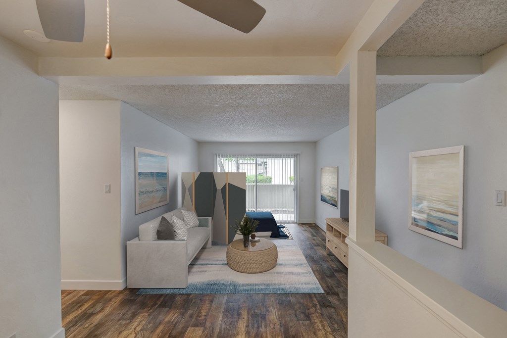 a living room with a couch and a table and a window