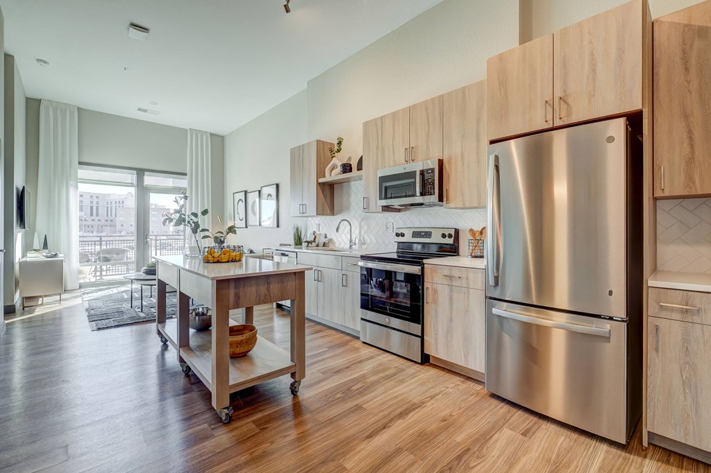 Model kitchen with light wood cabinetry and stainless steel appliances  at Novus, Lone Tree
