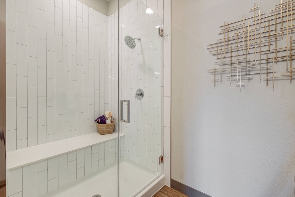 Bathroom with glass enclosed shower and shower ench at Novus, Colorado