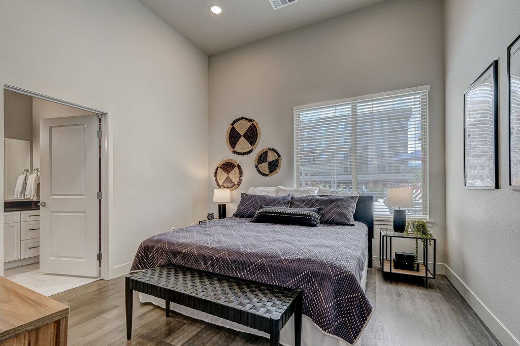 a bedroom with a large bed in front of a window
