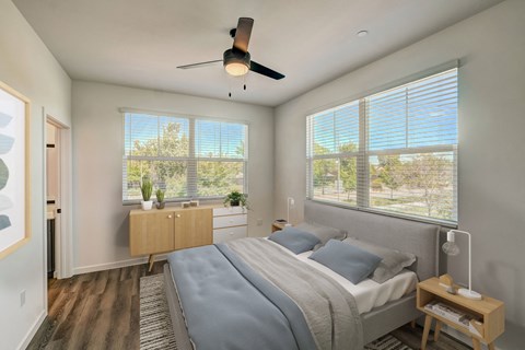a bedroom with a bed and a ceiling fan
