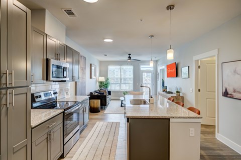 A modern kitchen with stainless steel appliances and a large island.