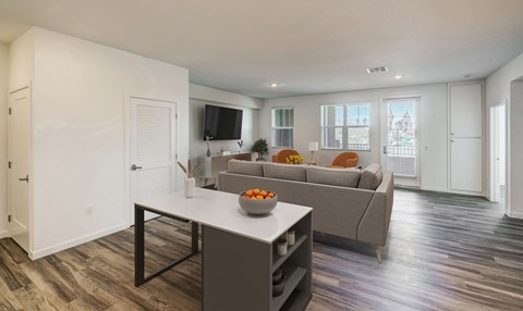 a living room with a couch and a table and a television