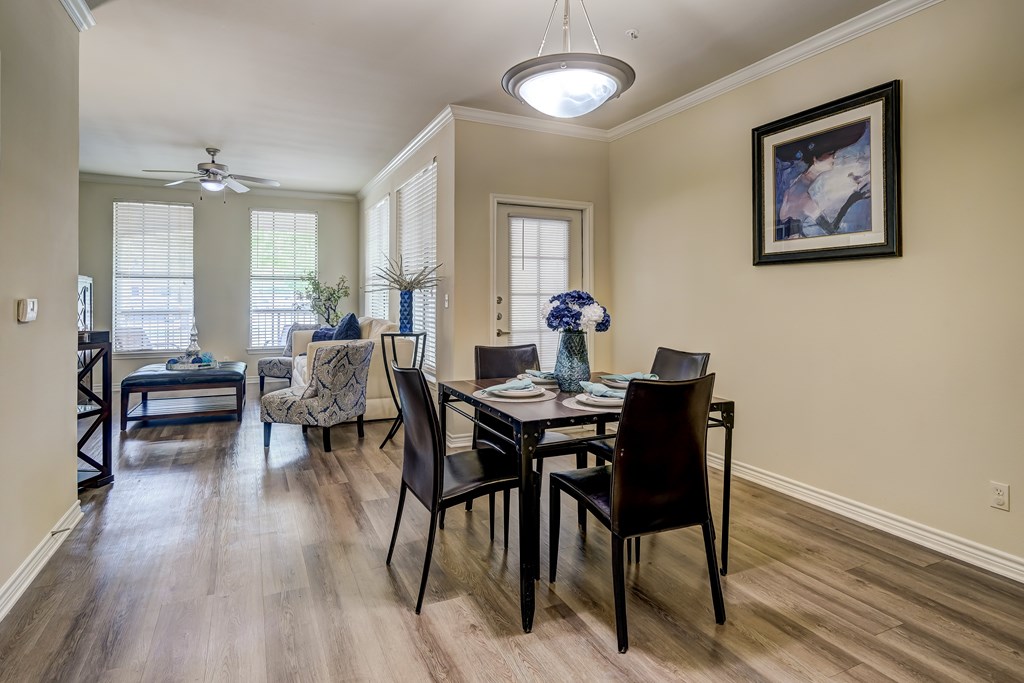 A dining room with a table set for four.