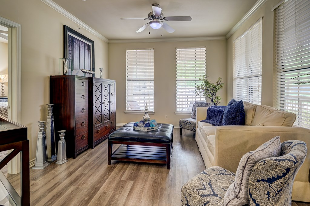 A living room with a brown coffee table and a blue cushion.