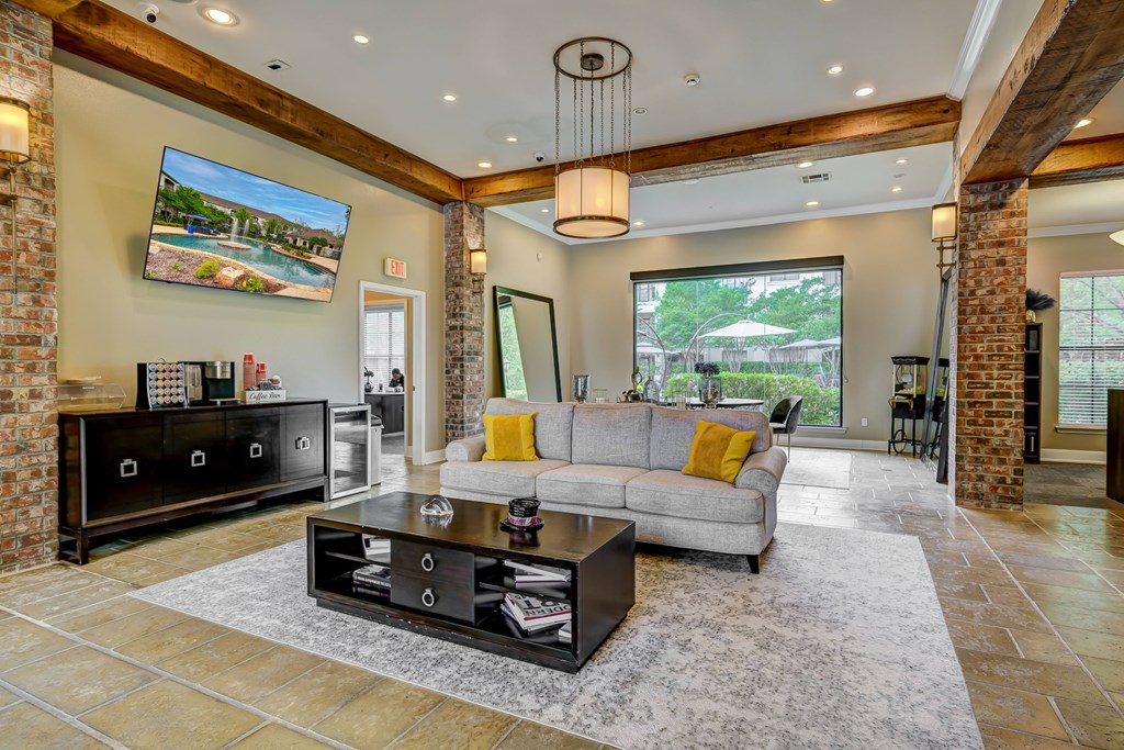 A modern living room with a grey sofa and a black coffee table.