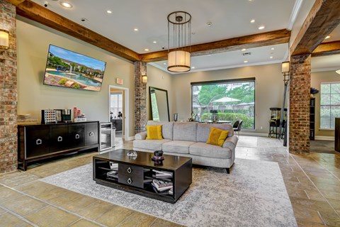 A modern living room with a grey sofa and a black coffee table.