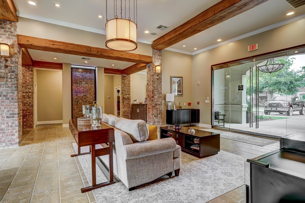 A living room with a couch, a coffee table, and a television.