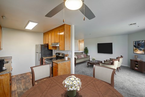 A kitchen with a table and chairs in the foreground.