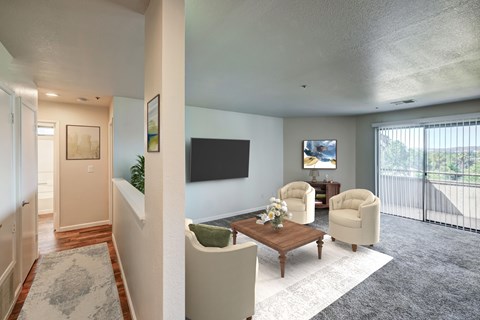 A living room with a flat screen TV and a balcony.