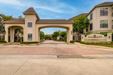 A large archway entrance to a residential area with the name