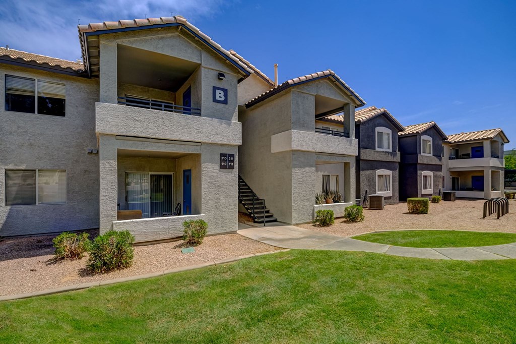 a row of houses with a yard and grass
