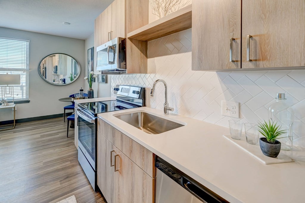 a kitchen with wooden cabinets and a sink with a view of dining area at Novus, Colorado, 80124