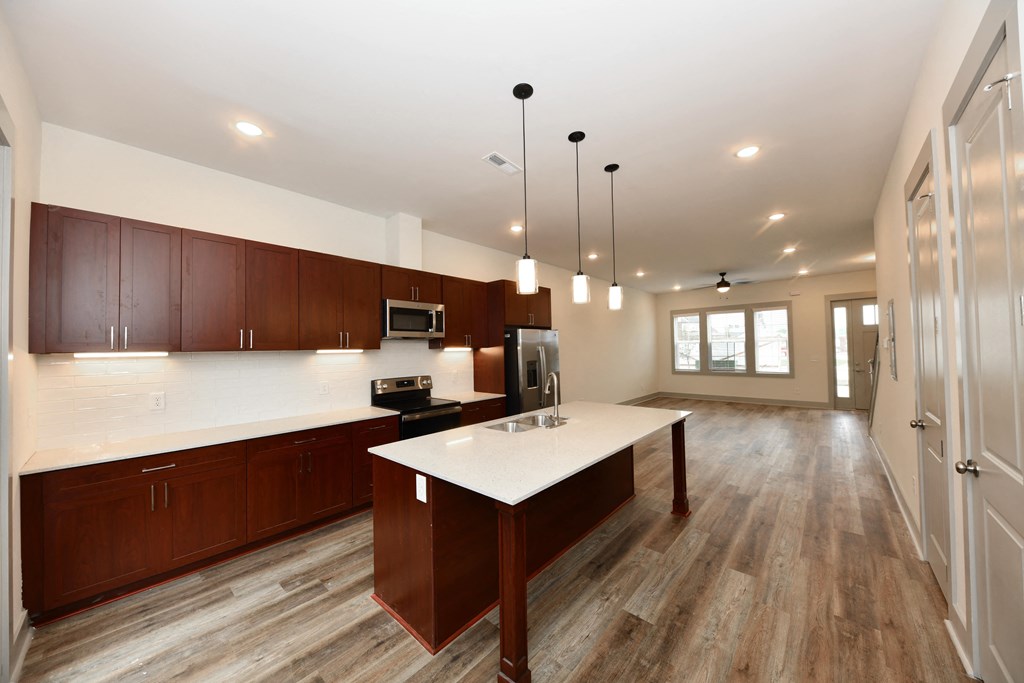 A kitchen with brown cabinets and a white island.