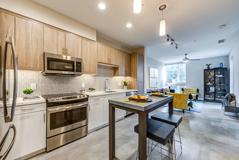 A modern kitchen with a dining table and chairs.